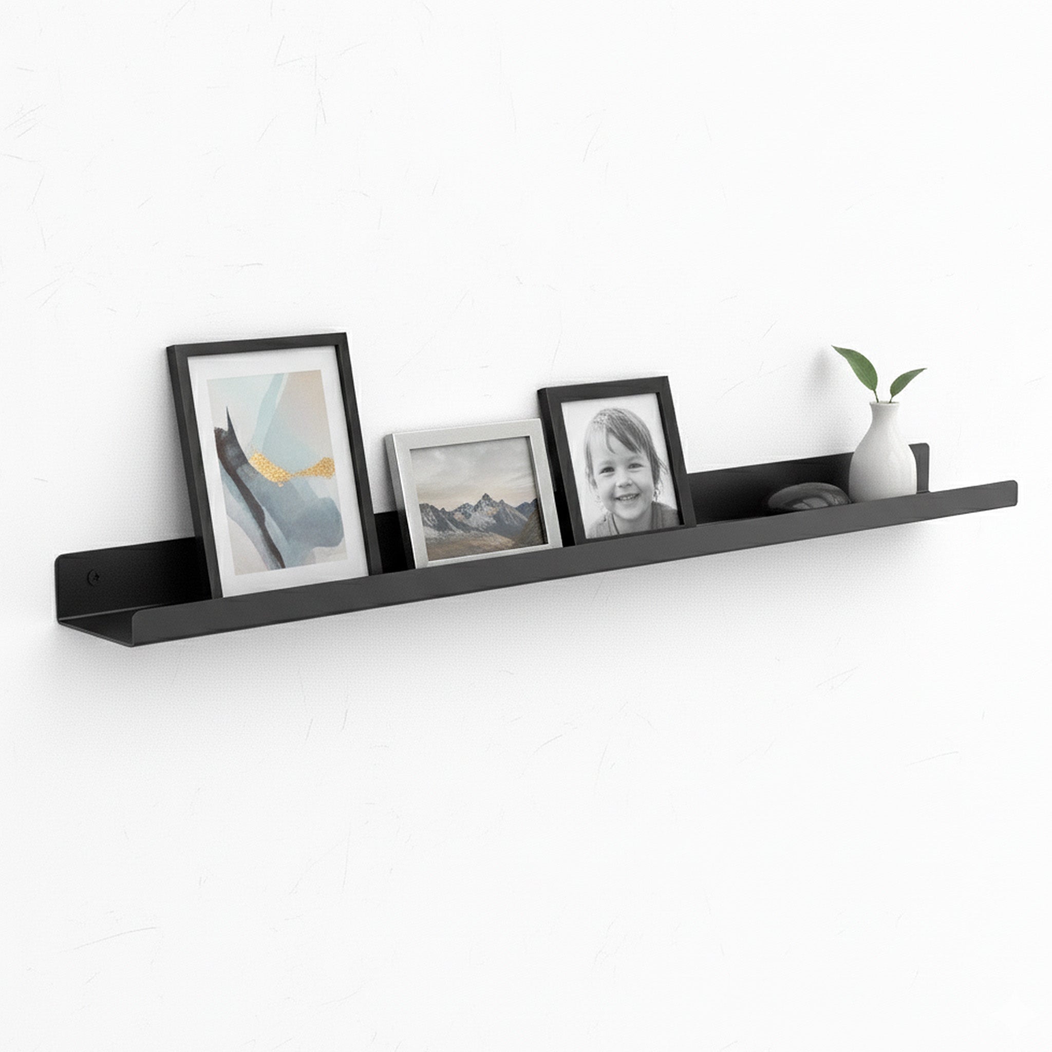 600mm wide black metal lip shelf mounted on wall displaying photo frames and a small vase, made from durable 1.6mm mild steel with powder-coated finish, ideal for home or office decor